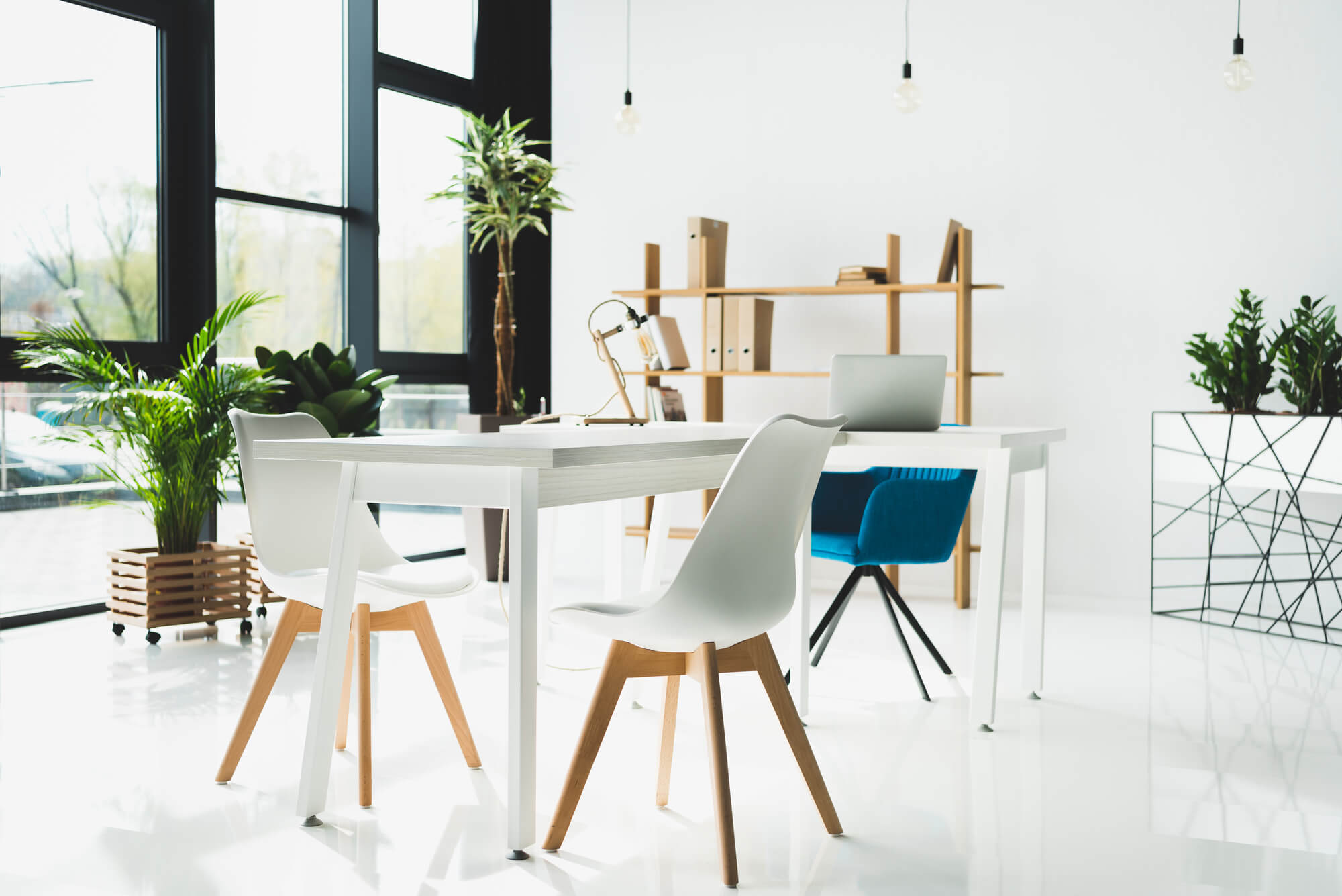 White elegant office interior design with tables and chairs