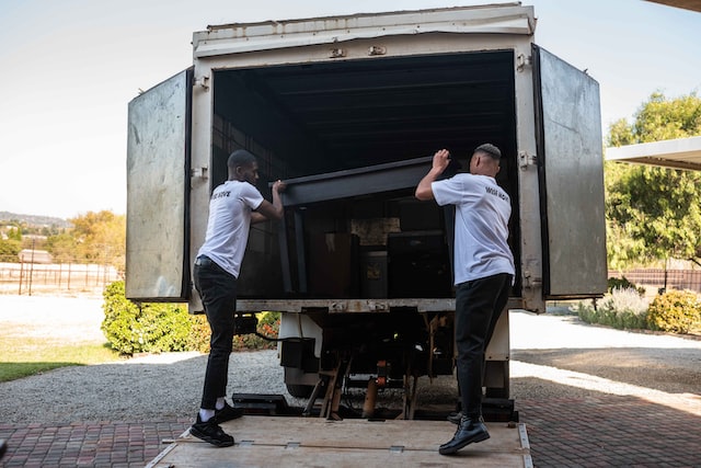 2 men loading portable storage